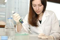 A researcher pipetting things