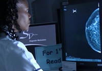 A nurse looking at a mammogram