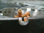 An ashtray with cigarette butts in it
