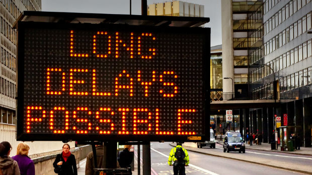 Street sign: "Long Delays"