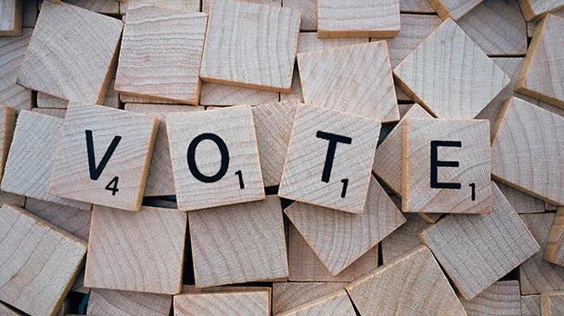 Scrabble pieces spelling out word 'vote'