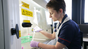 A research nurse processing trial samples