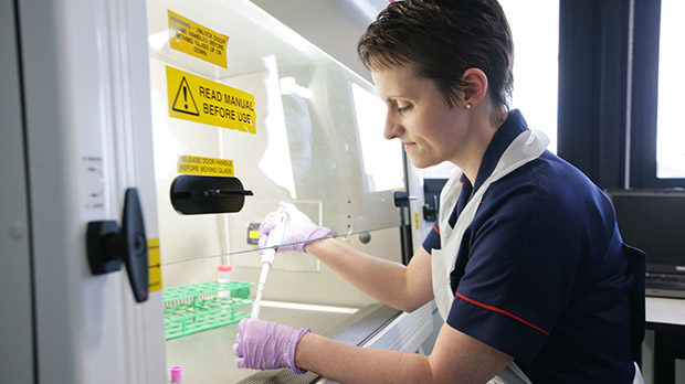 A research nurse processing trial samples