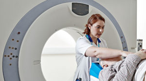Image of an MRI scanner and a radiographer