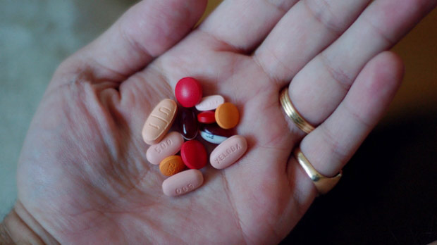 Pills in a person's palm.