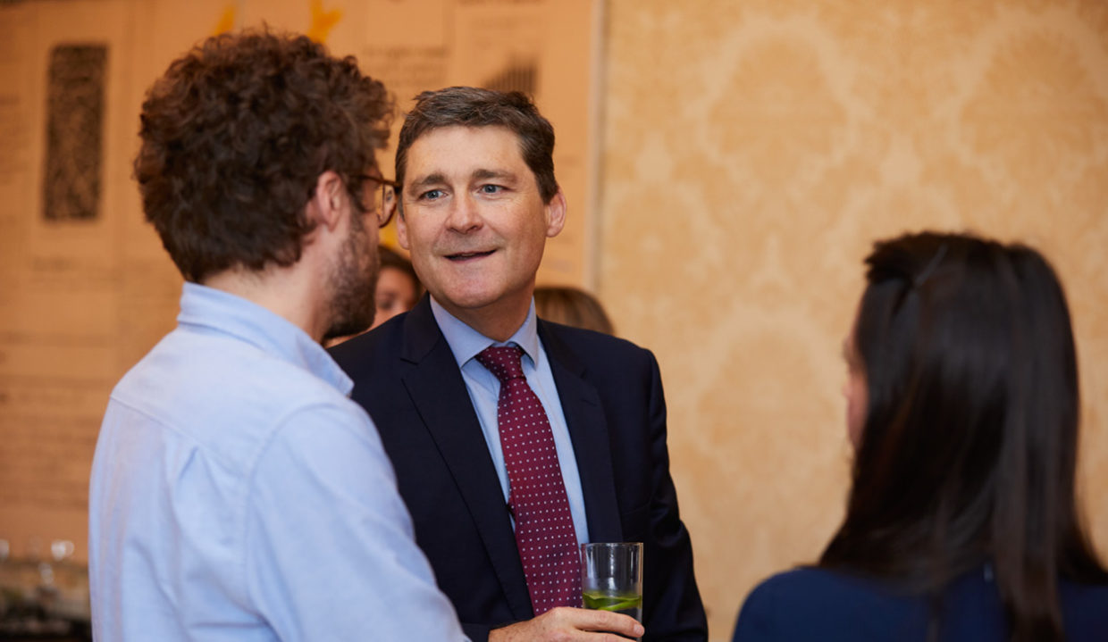 Chris Gethin speaking to a donor at a Cancer Research UK event