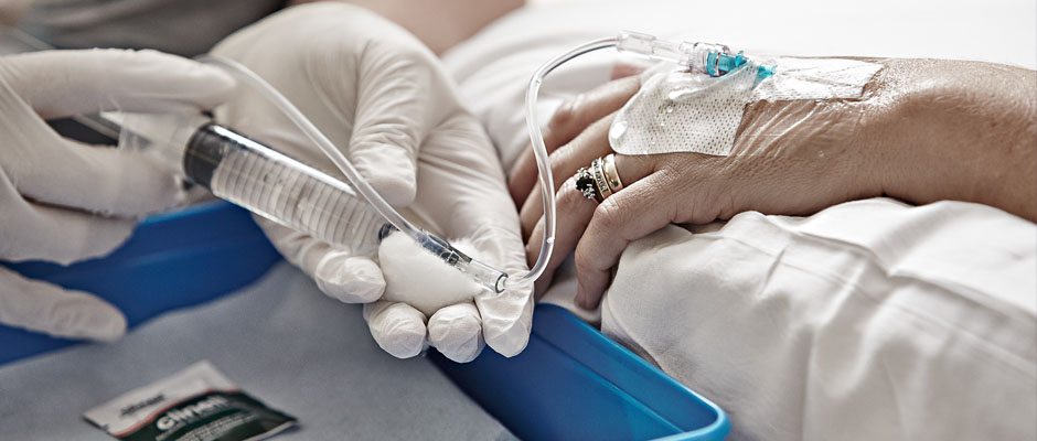 Close up photo of two hands as one administers treatment to the other
