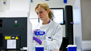 A scientist looking at samples in a lab
