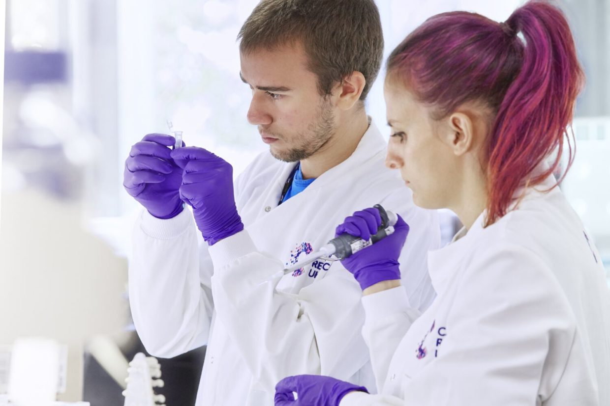 Two early-career scientists working in a lab
