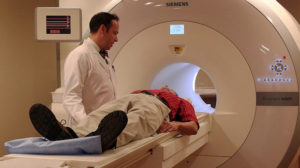Photograph of a person having an MRI scan.