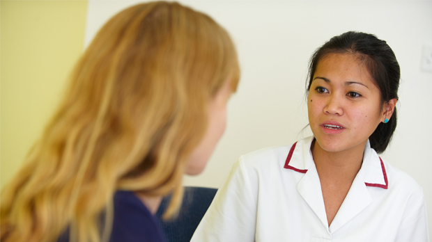 Female patient talking with nurse