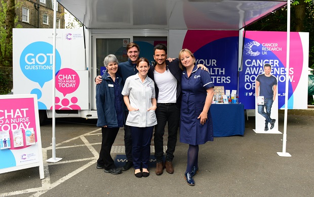 Peter Andre with nurses aboard the London Cancer Awareness Roadshow