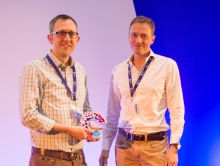 Edd James receiving his CRUK Inspiring Leadership Research Engagement prize from Iain Foulkes