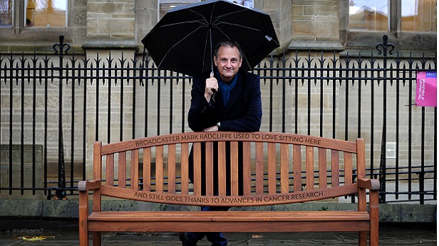 BBC broadcaster Mark Radcliffe today launched ‘Re-Write Cancer’ Cancer’ - a £20m fundraising campaign - by unveiling an engraved park bench in the grounds of the University of Manchester