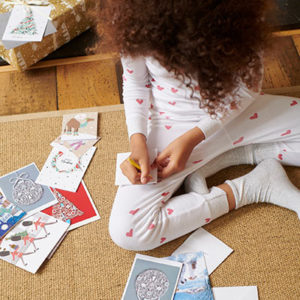 Child writing Christmas cards