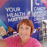 A photo of Alex, volunteering at our Cancer Awareness Roadshow