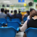 Image of a woman waiting in a hospital waiting room