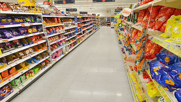 Supermarket shelves filled with crisps and sweets