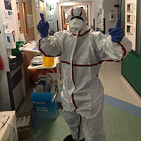 Kizi at work as an intensive care nurse wearing PPE during the pandemic