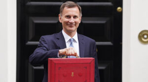 Image of Jeremy Hunt holding the red budget briefcase