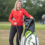 Lysa Jones standing on a golf green with some golf clubs