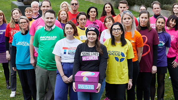 One Cancer Voice campaigners pose with a box of the 76,578 petition signatures