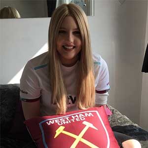 Katie during her treatment. She's dressed in the colours of her favourite football team: West Ham. 