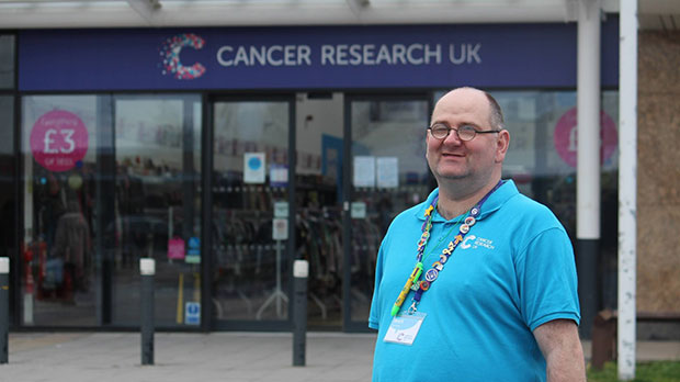 Brett outside the Cancer Research UK shop he volunteers in