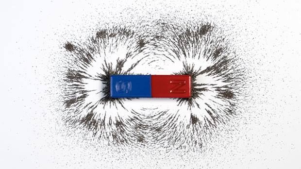 A simple magnet attracting iron filings to its north and south poles, showing the shape of the magnetic field it creates