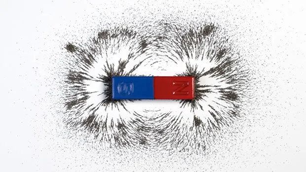 A simple magnet attracting iron filings to its north and south poles, showing the shape of the magnetic field it creates