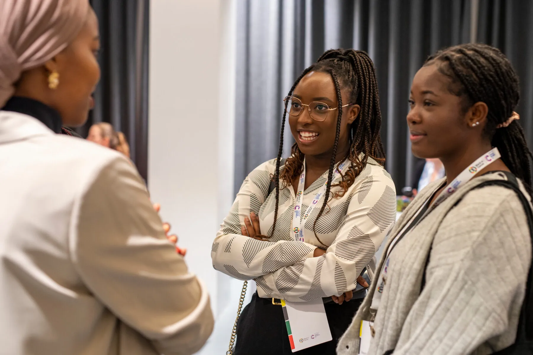 Three Black female researchers at a conference