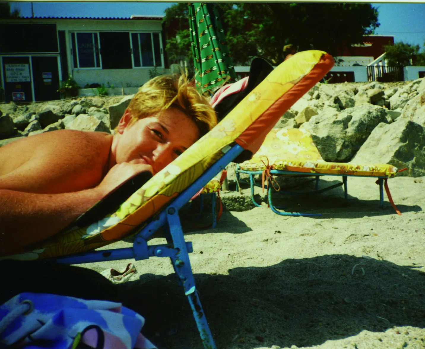 Justine sunbathing in her early twenties.