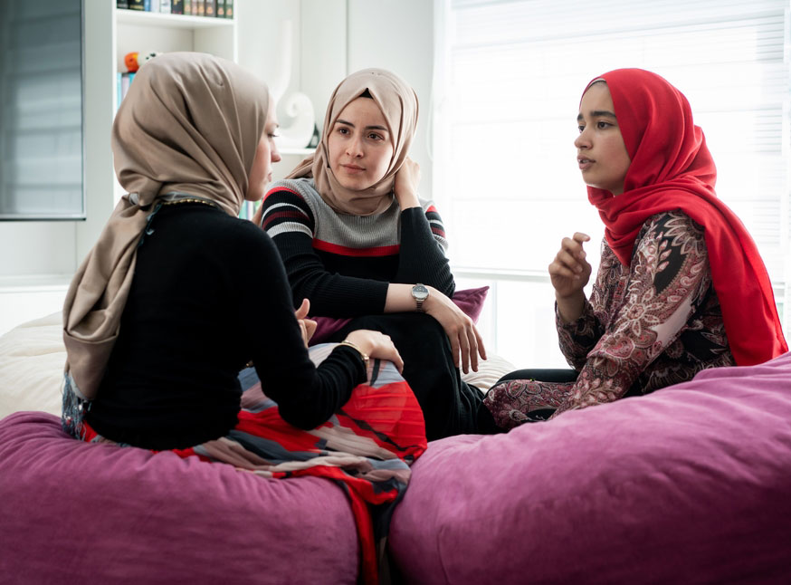 Three Muslim women talking