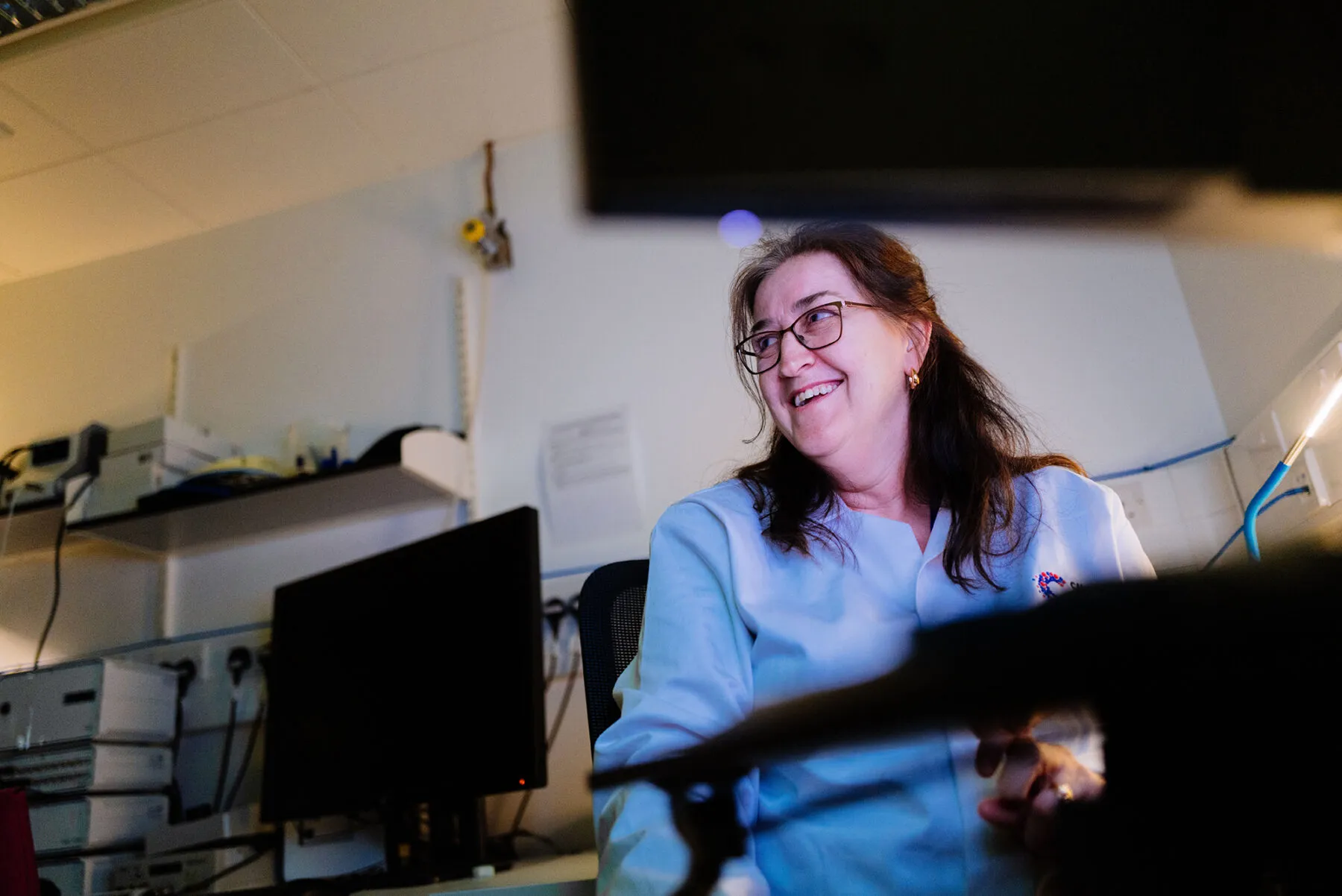 A female researcher in the lab smiling