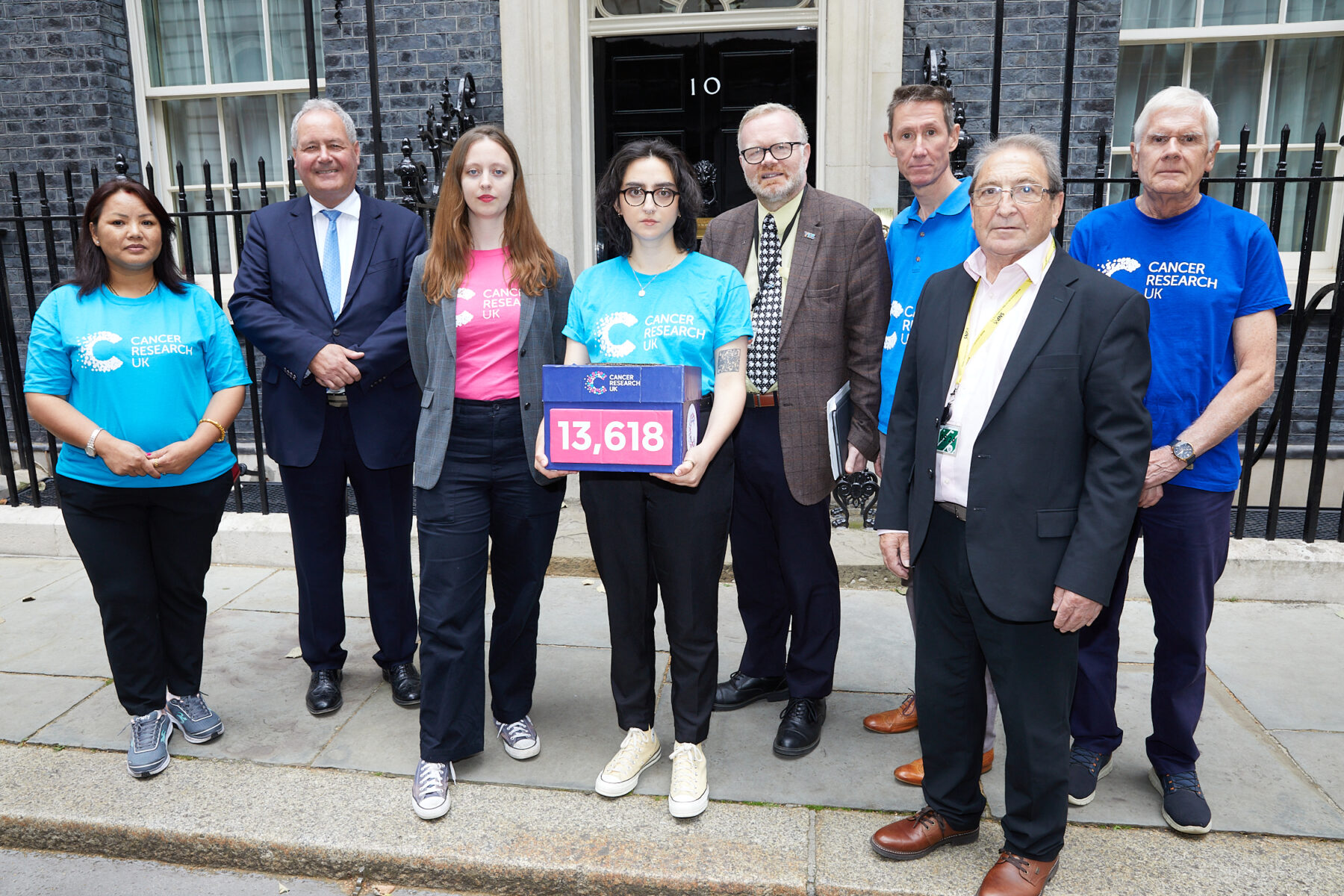 Cancer Research UK Campaigners outside number 10 Downing street with MPs Bob Blackman, John McNally and Martyn Day.