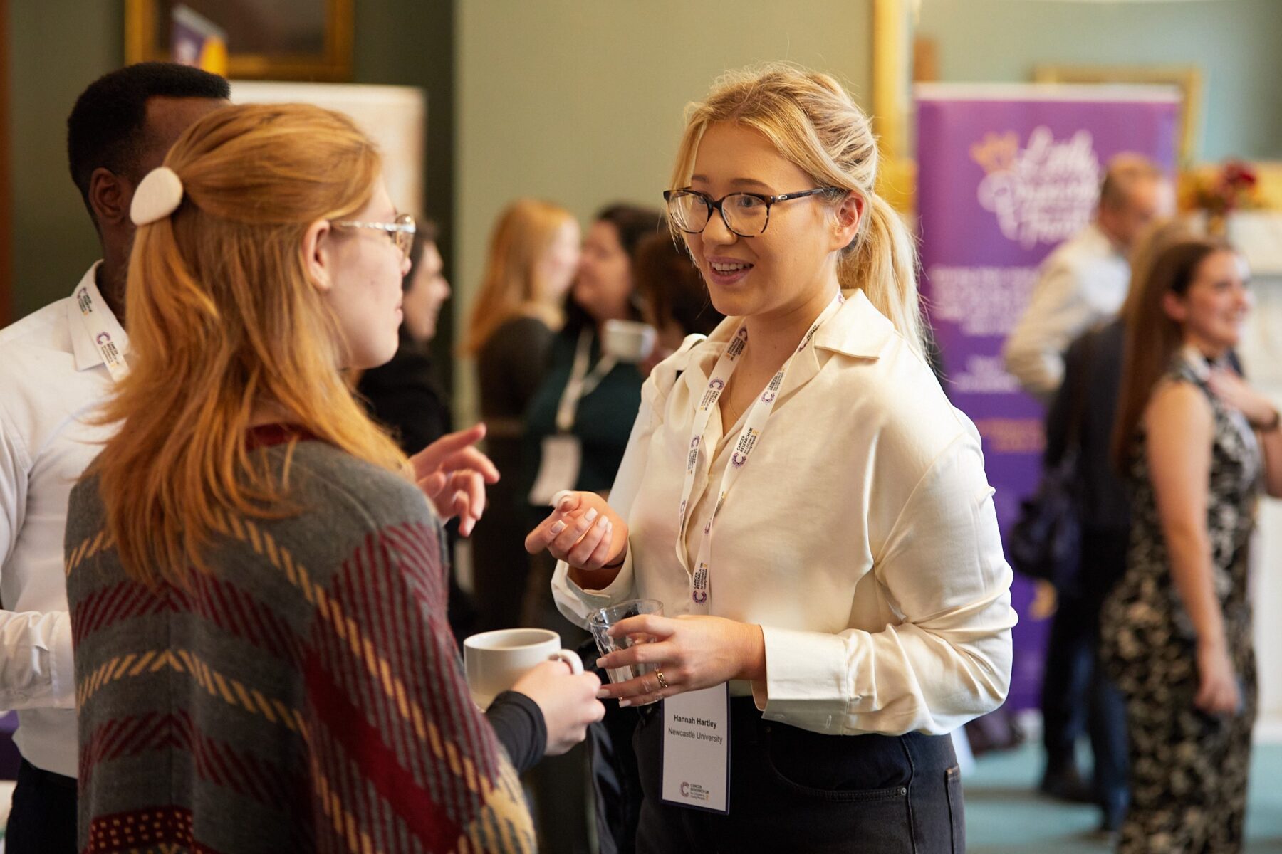 Group of attendees talking at the Children 's and Young People's Cancer Research Conference at The Royal Society