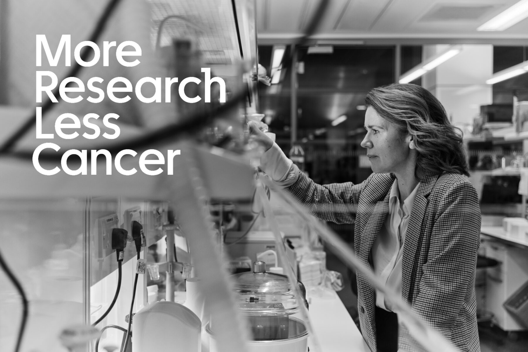 More Research, Less Cancer over an image of a researcher