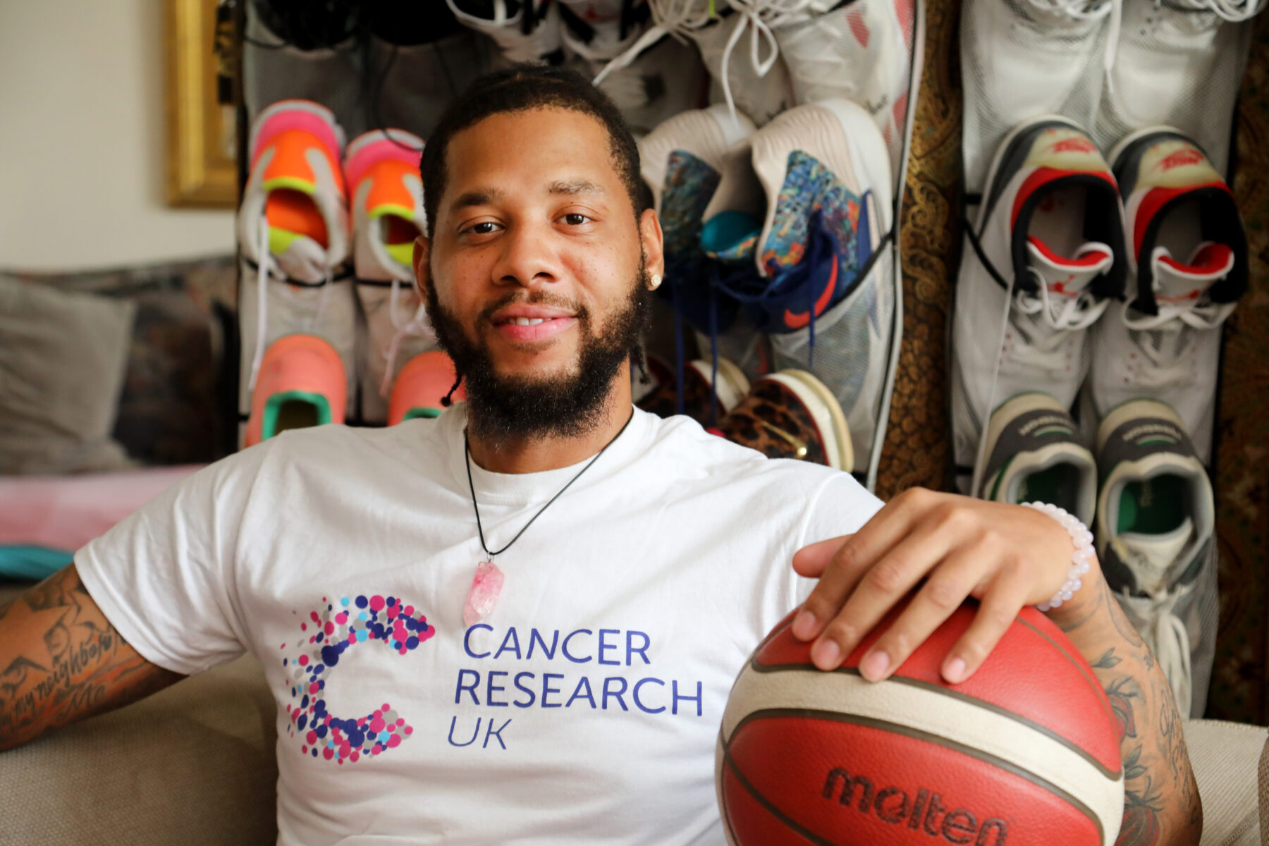 Basketball player Will Wise wearing a Cancer Research UK t-shirt