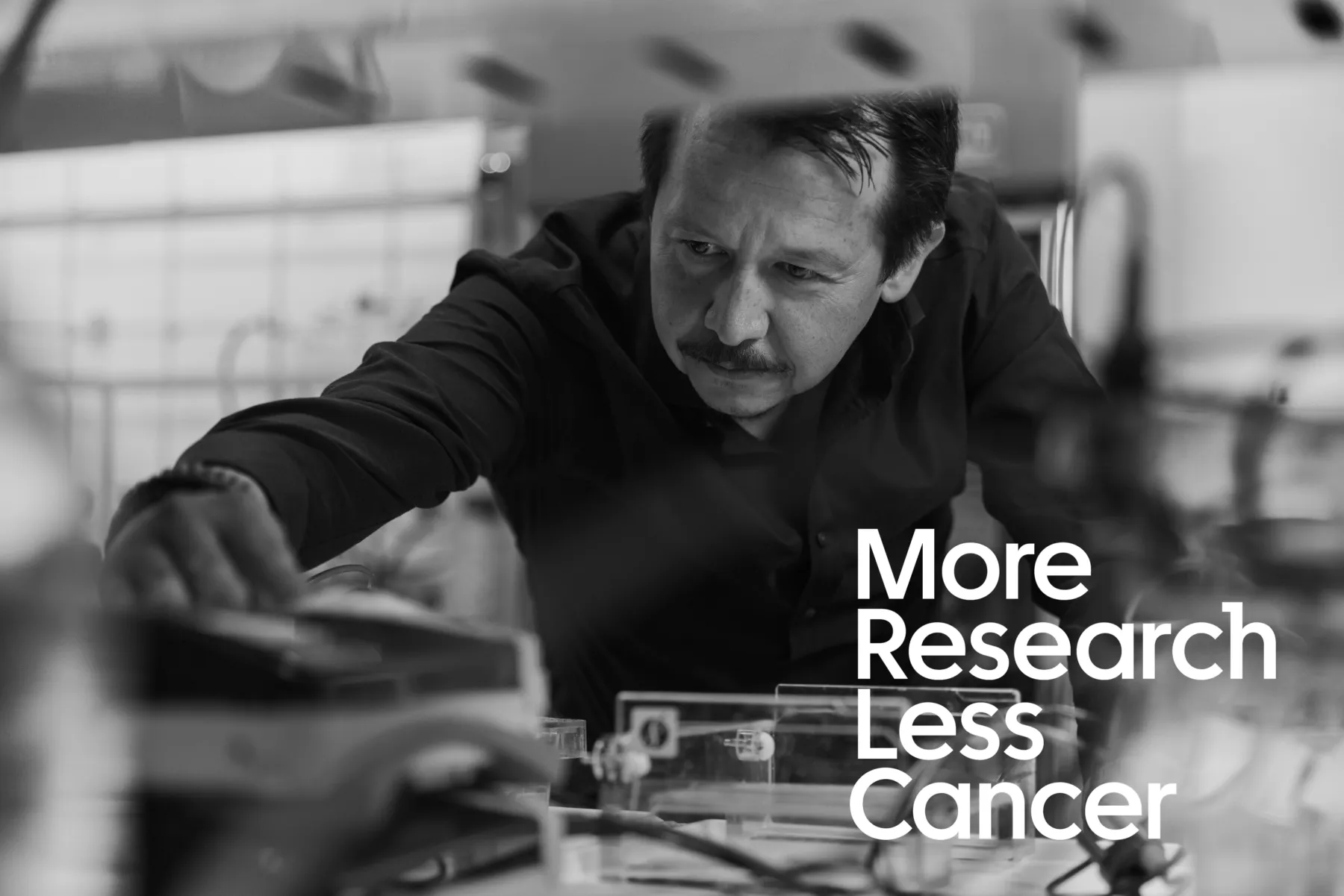 Photograph of Professor Sergio Quezada, with the More Research Less Cancer logo