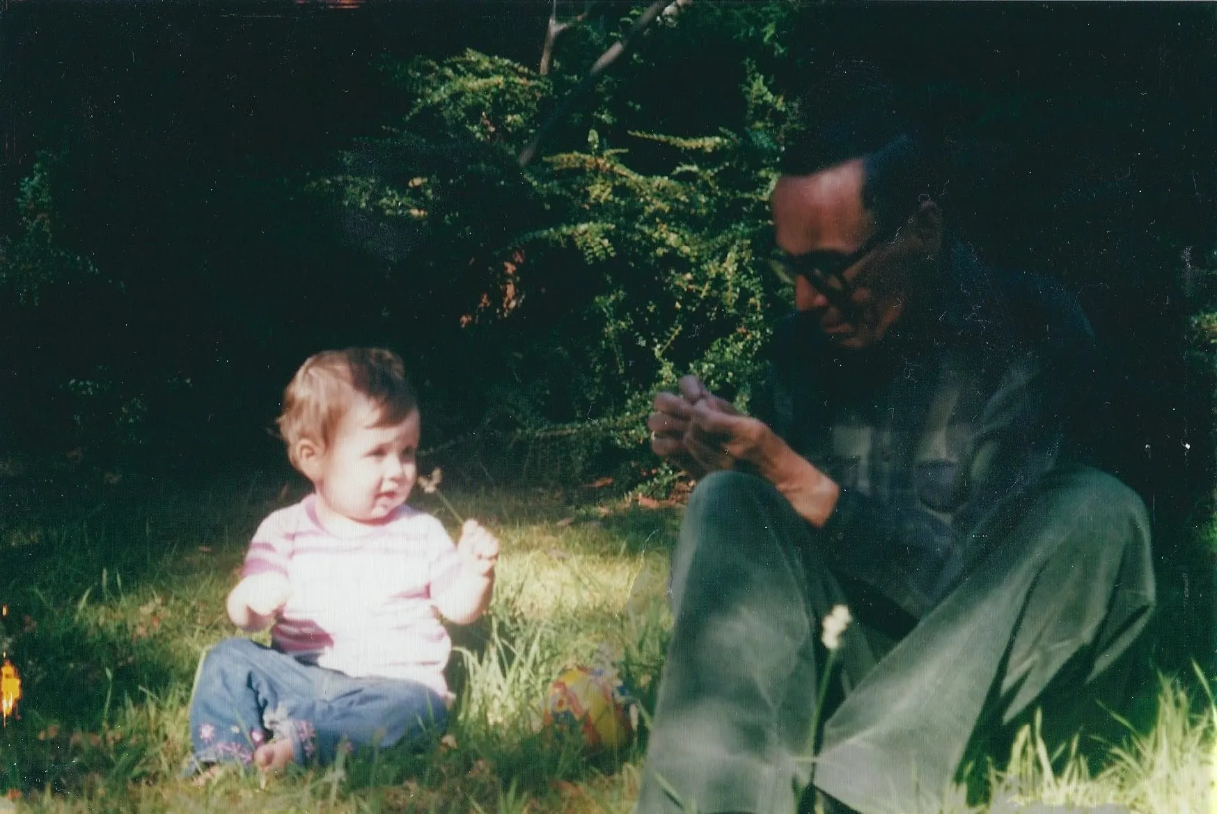 Gower's dad sitting outside with his granddaughter, Olivia, who is one year old