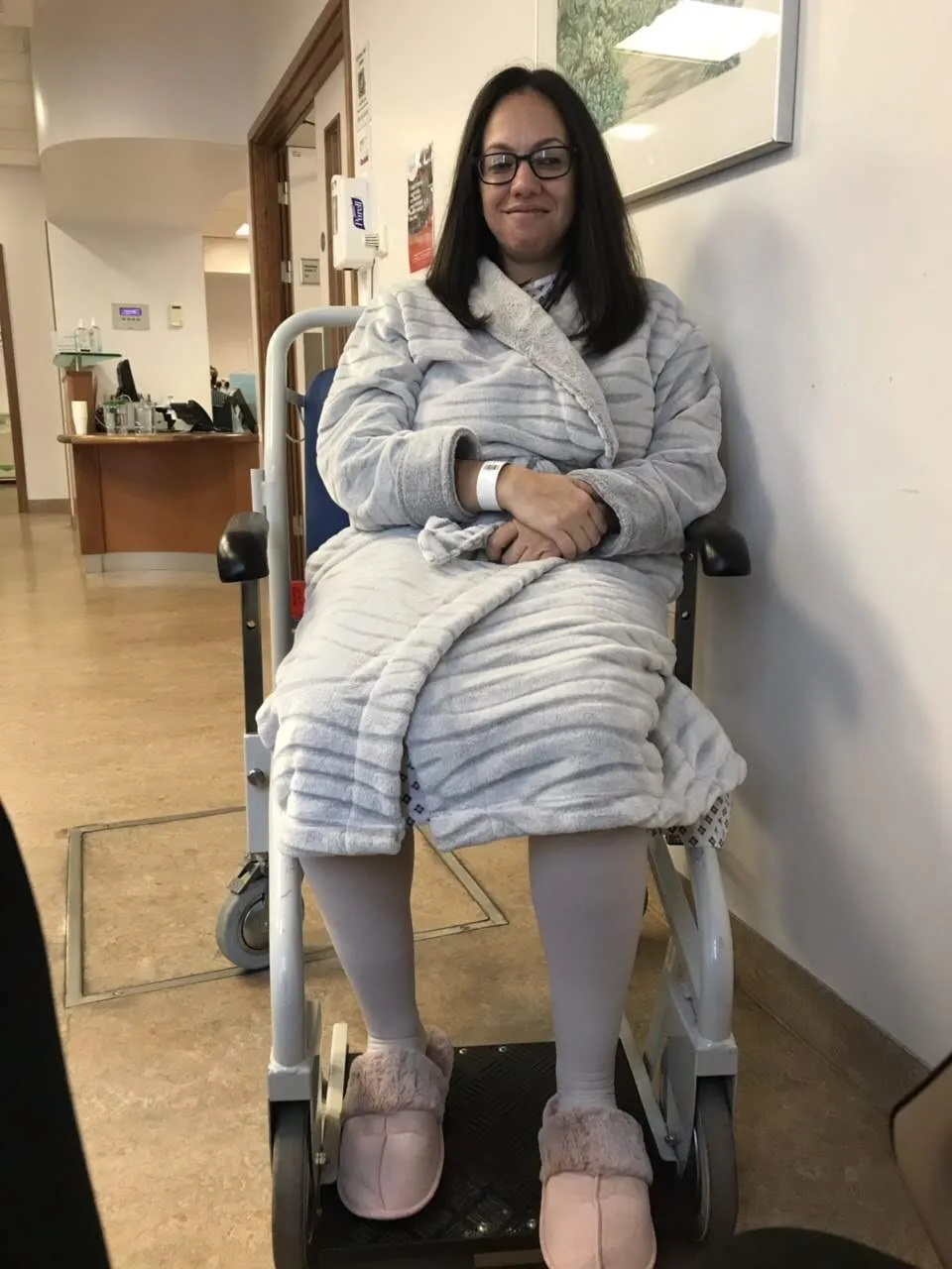 Maria sits in a wheelchair at hospital during her treatment