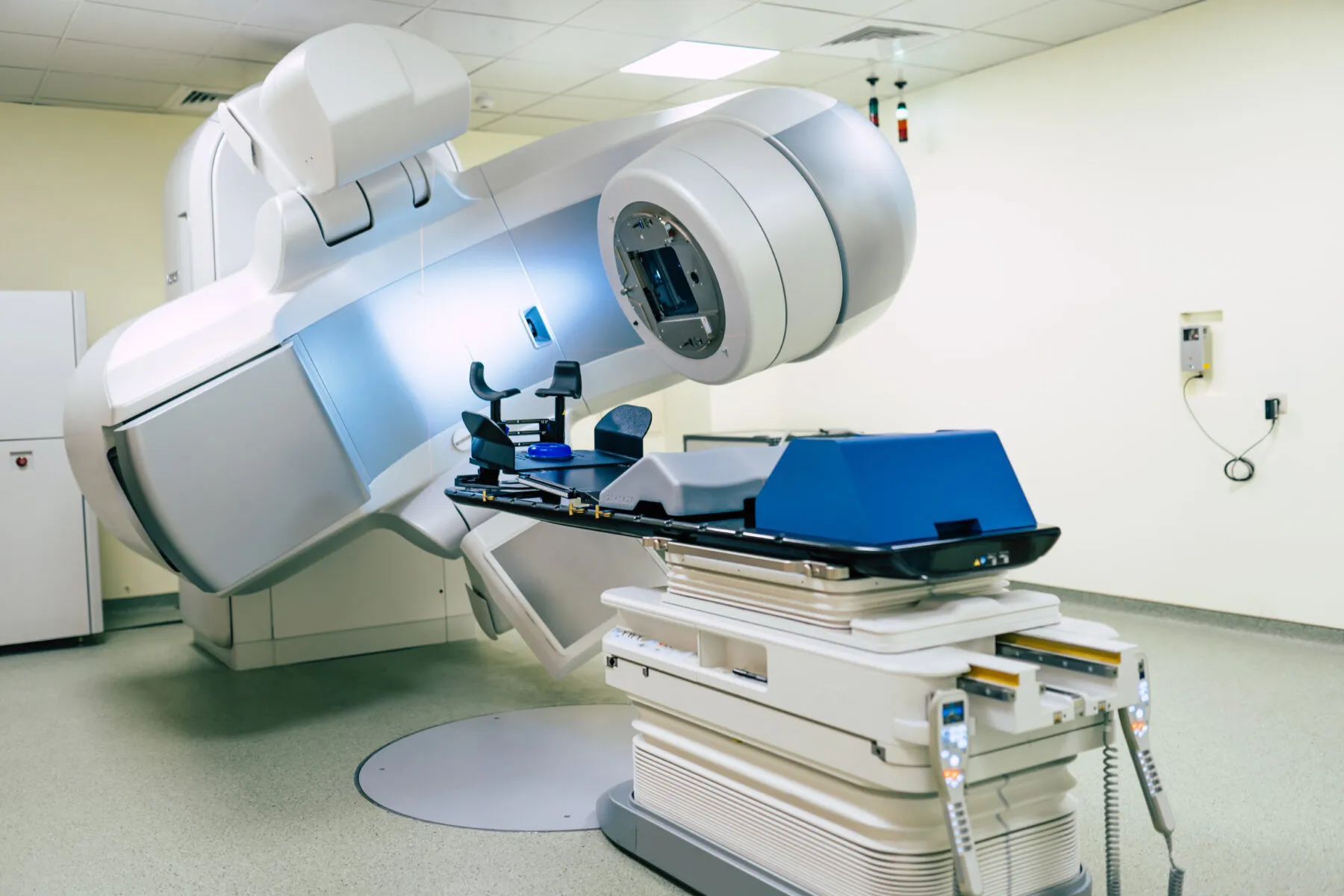 A radiotherapy machine in a hospital. It is tilted to show how it can move to target tumours.