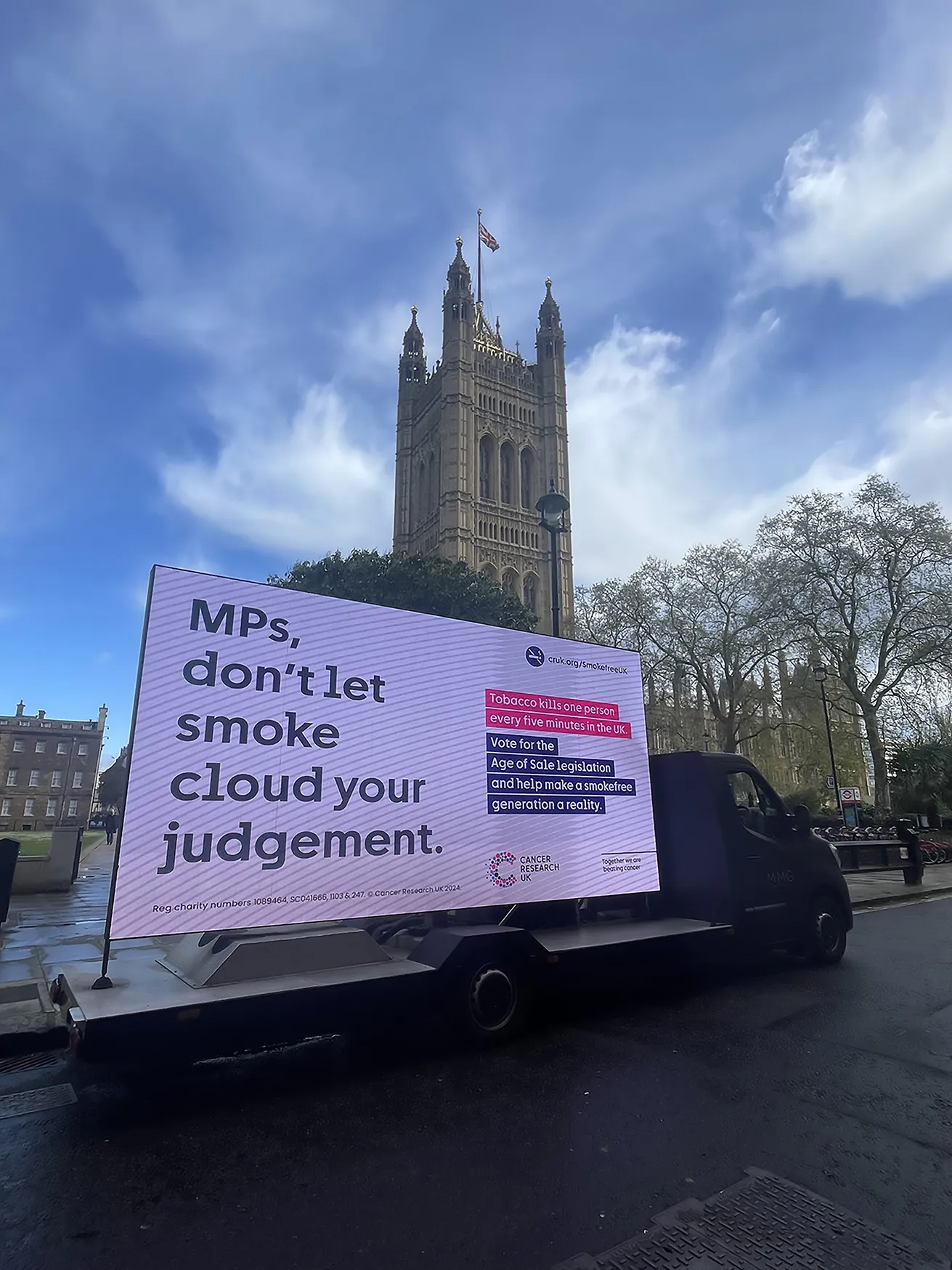 A digital van outside Westminster with a sign saying that says 'MPs don't let smoke cloud your judgement'