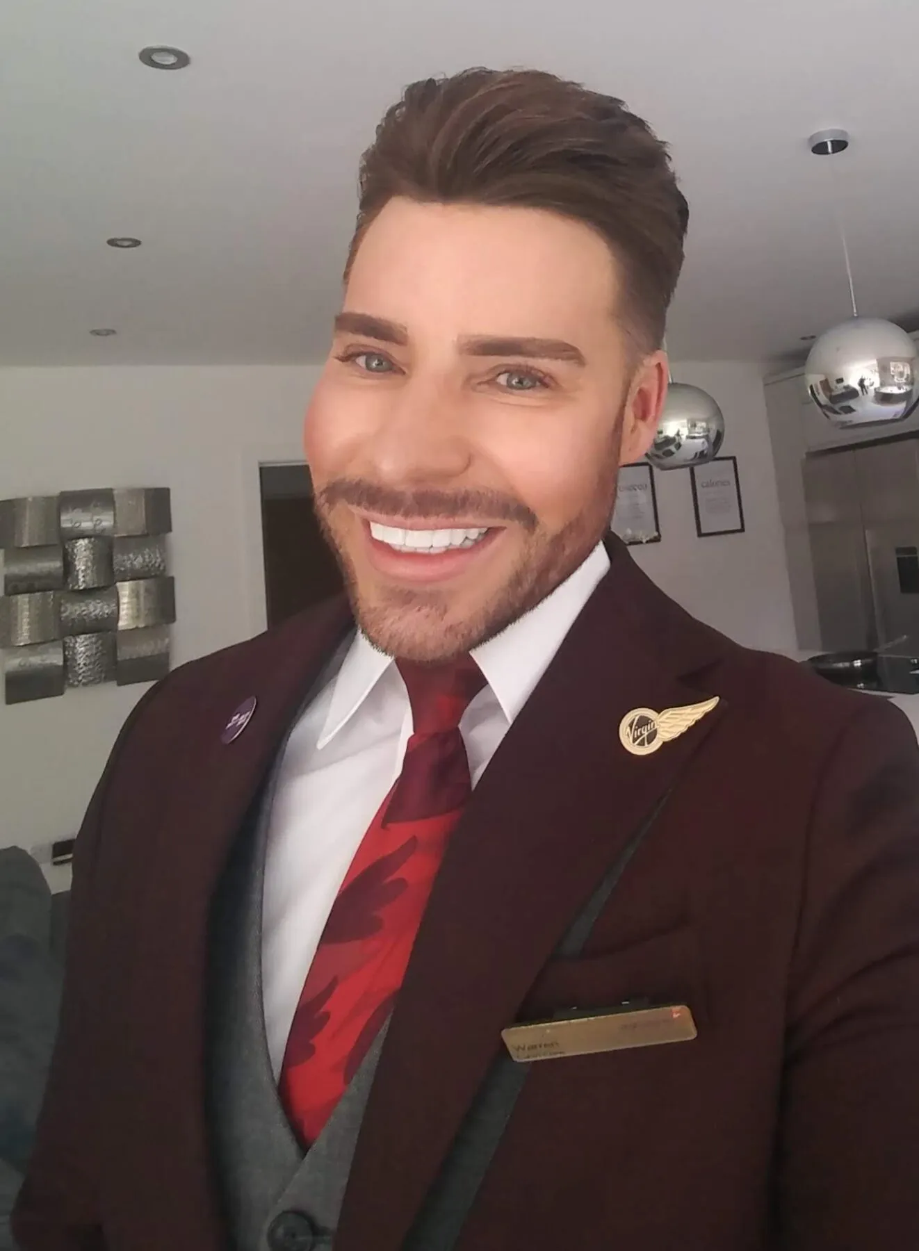 Warren smiling in his cabin crew uniform, before his diagnosis