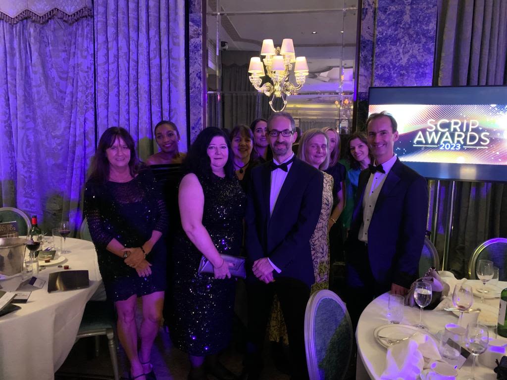 A group of people in black tie at an awards ceremony