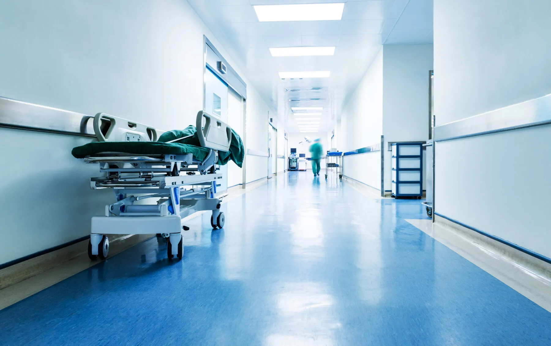 A doctor/nurse walking down a corridor in a hospital