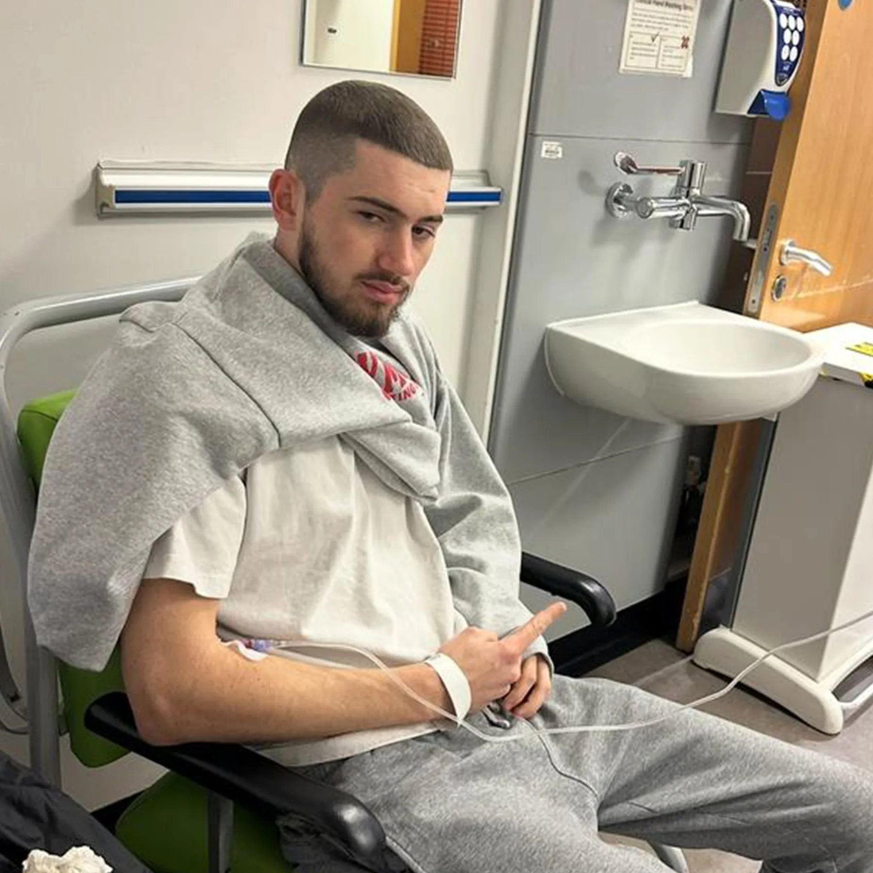 Taylor sat in hospital during his treatment.