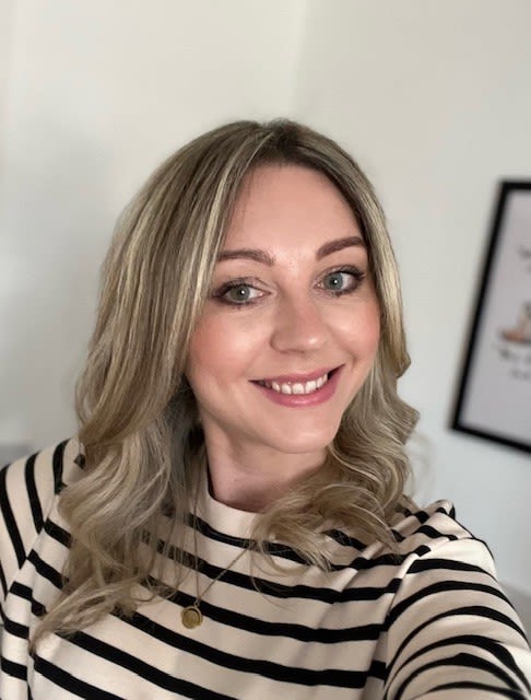 A headshot of Carla smiling