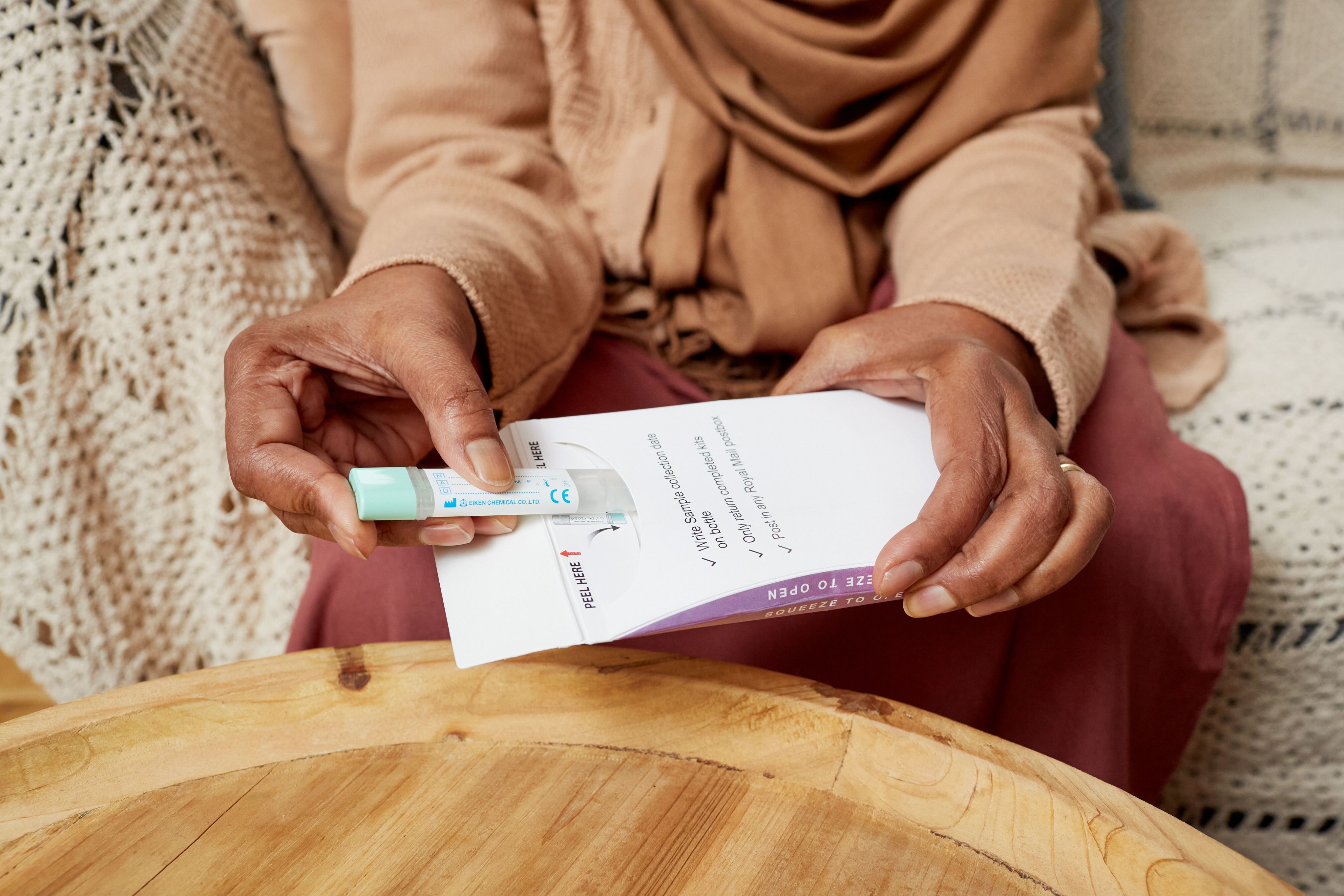 A woman holding a FIT test