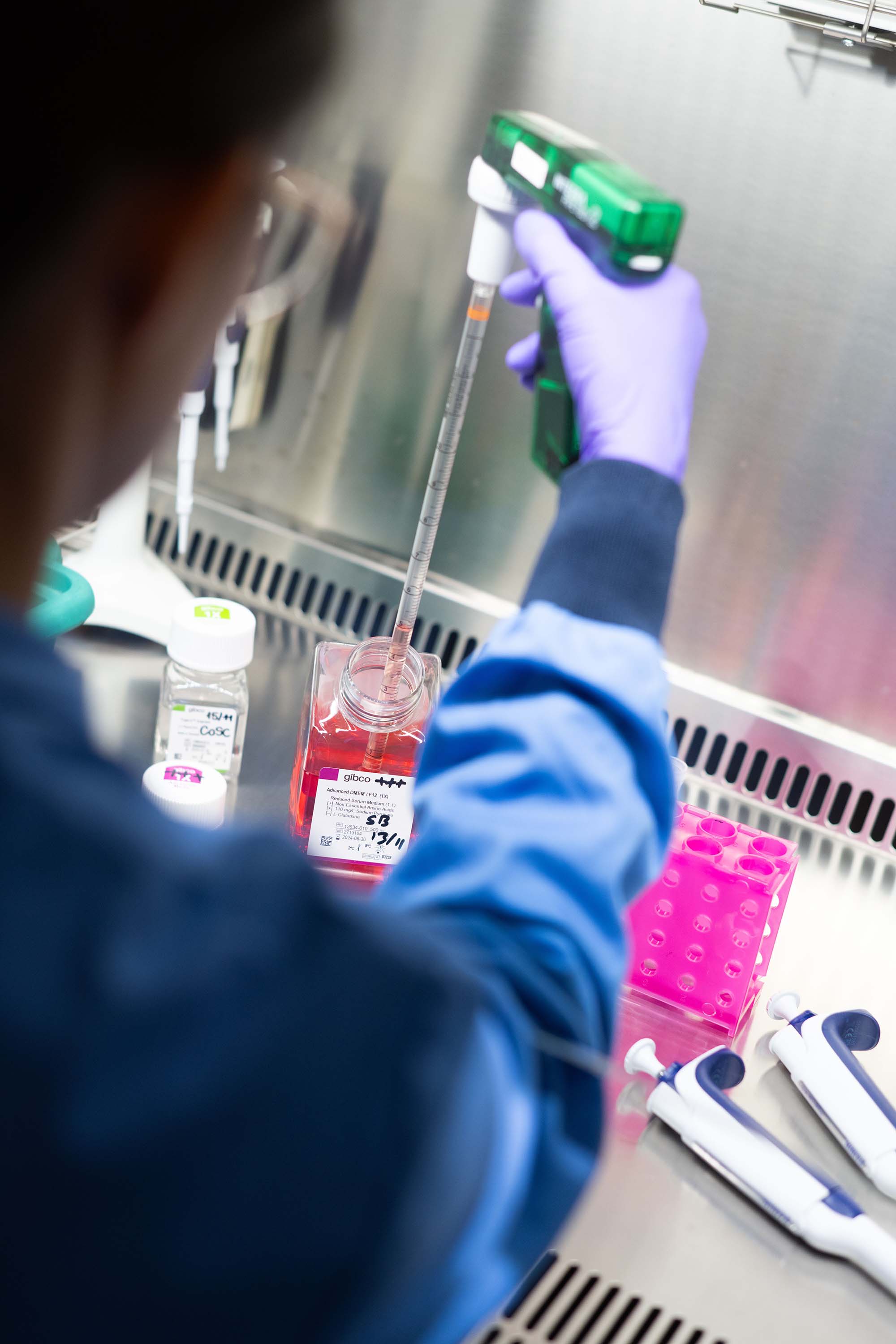 A researcher transferring a sample